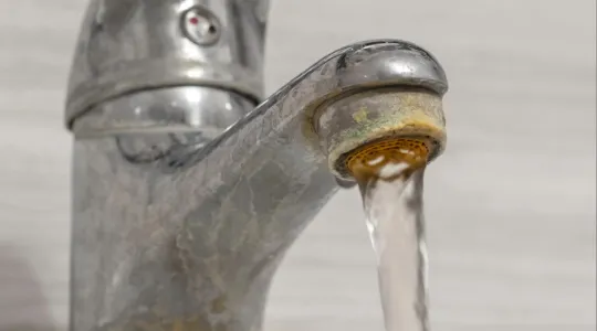 Hard water coming out of a faucet
