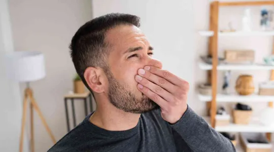 man smelling a bad odor in Metairie home