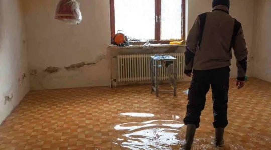 flooded basement with man walking in the water