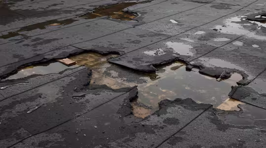 storm damaged flat commercial roof