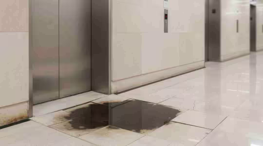 water damage at the base of a elevator
