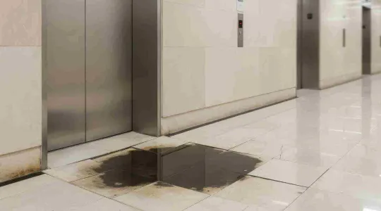 water damage at the base of a elevator