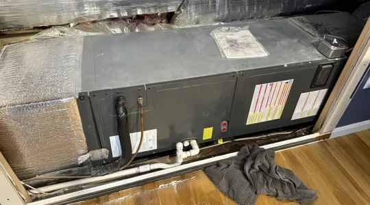 HVAC system leak with puddles on the wood floor